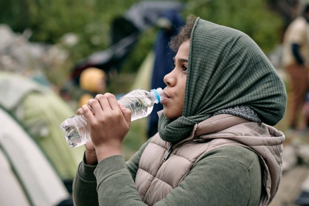 Migrant Girl Drinking Water